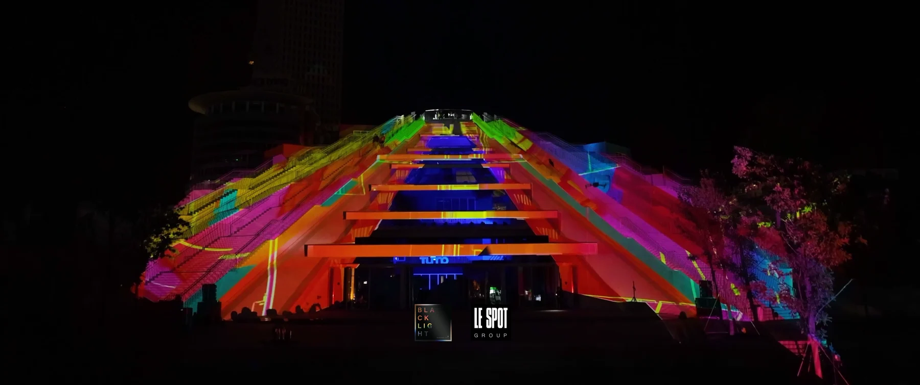 Colourful projection follows the sloping architecture of the Tirana Pyramid during a TUMO event