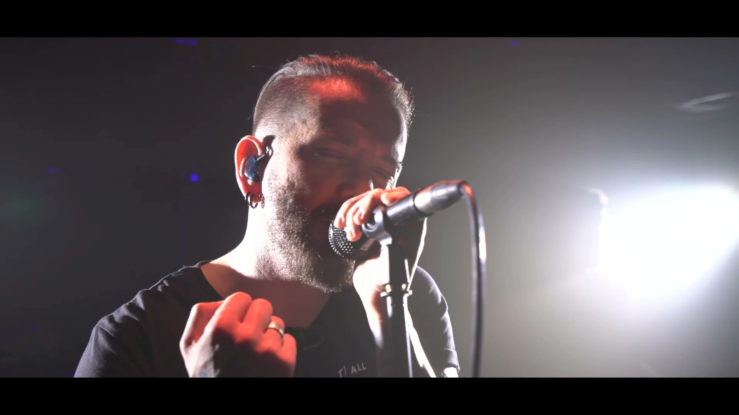 A Live Night — Expressive live singer with high-contrast white concert backlighting; actual 4K performance frame.
