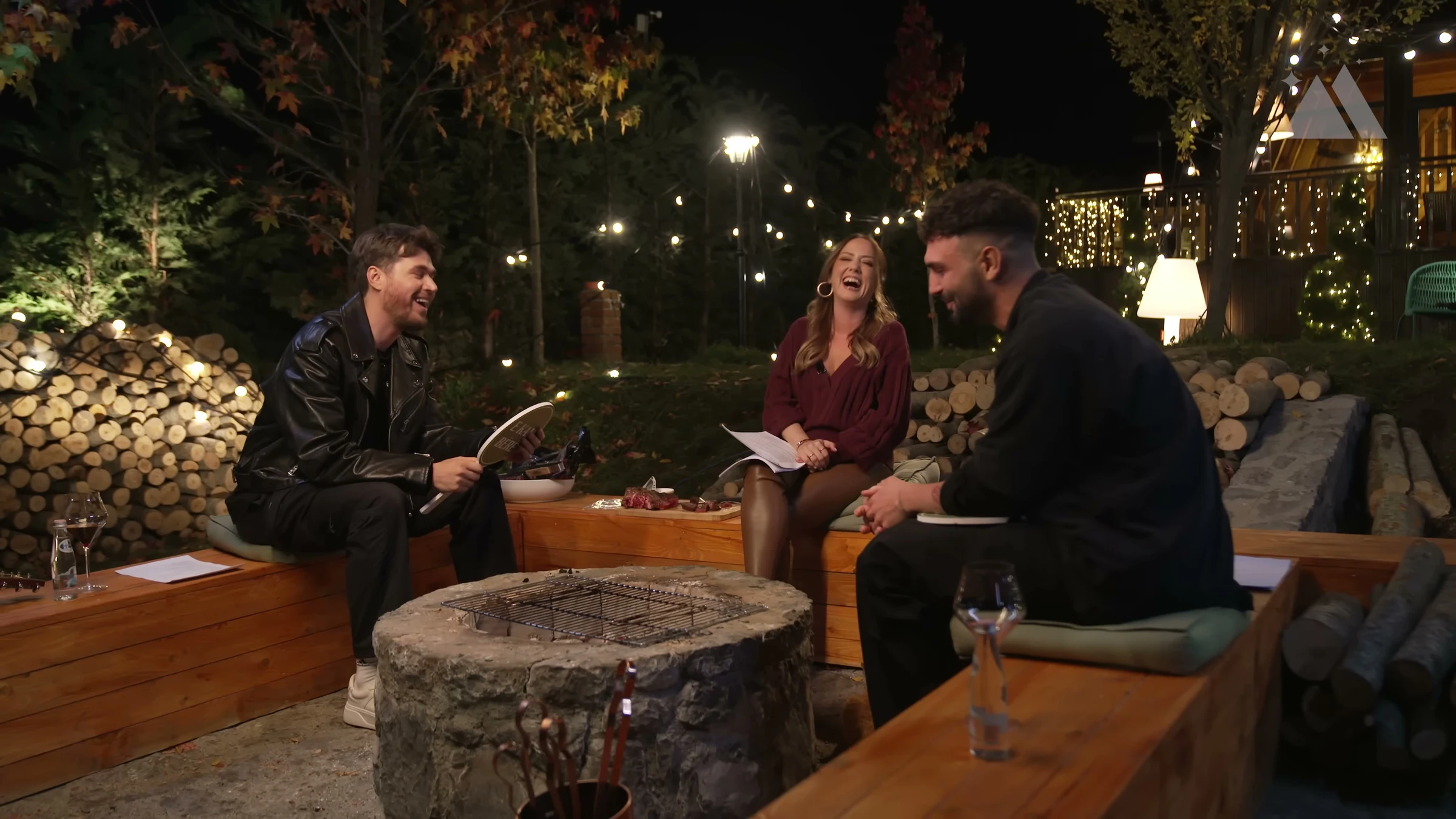 Mirëmbrëma Yje — Seasons 1 & 2 — Authentic warm evening three-person conversation, candid laughter, cinematic practical lights.